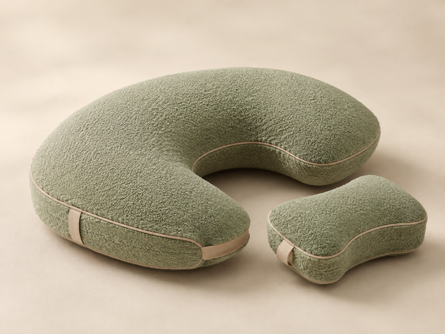 Sage green modular crescent side-sleeping pillow with a detachable knee support cushion